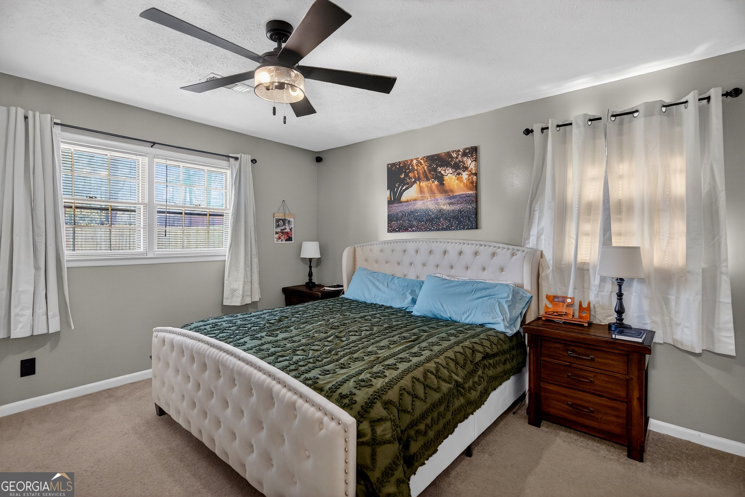 2404 19th Avenue Valley, AL 36854 - Photo 17 of 24 a bedroom with a bed and a chandelier