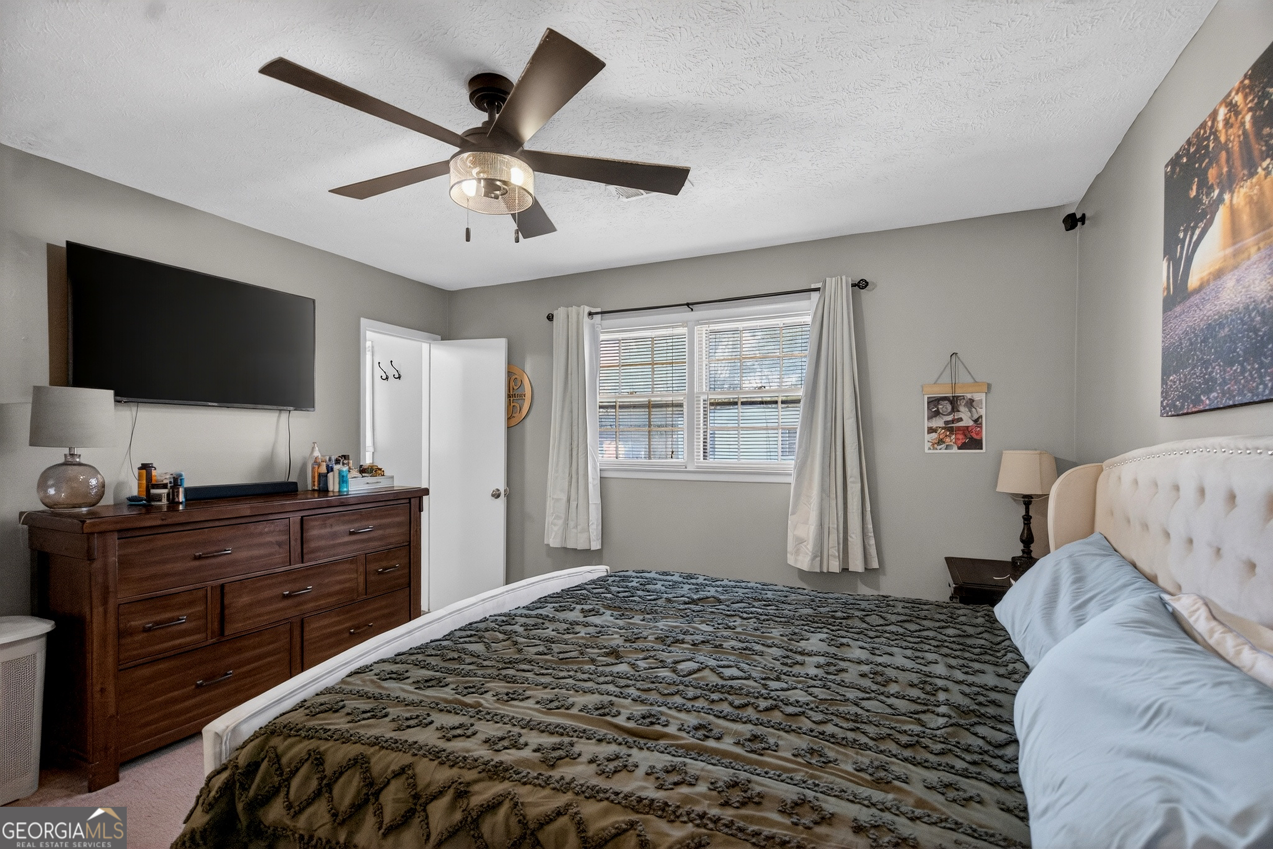 2404 19th Avenue Valley, AL 36854 - Photo 18 of 24 a bedroom with a bed and a flat screen tv