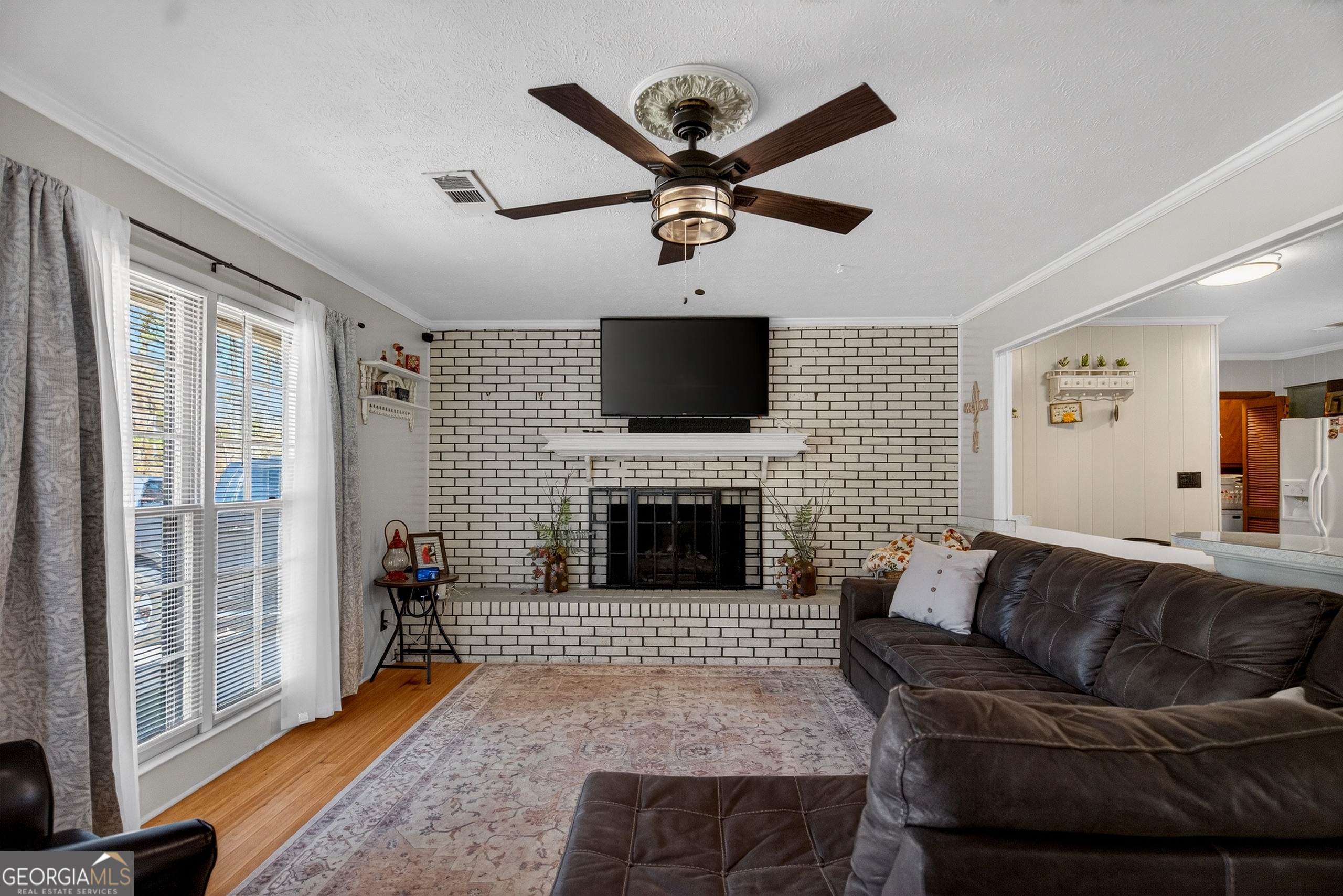 2404 19th Avenue Valley, AL 36854 - Photo 5 of 24 a living room with furniture a fireplace and a flat screen tv