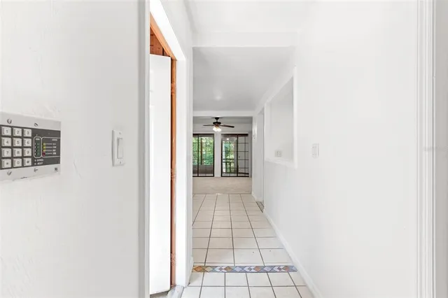 a view of a hallway with wooden floor and a white wall