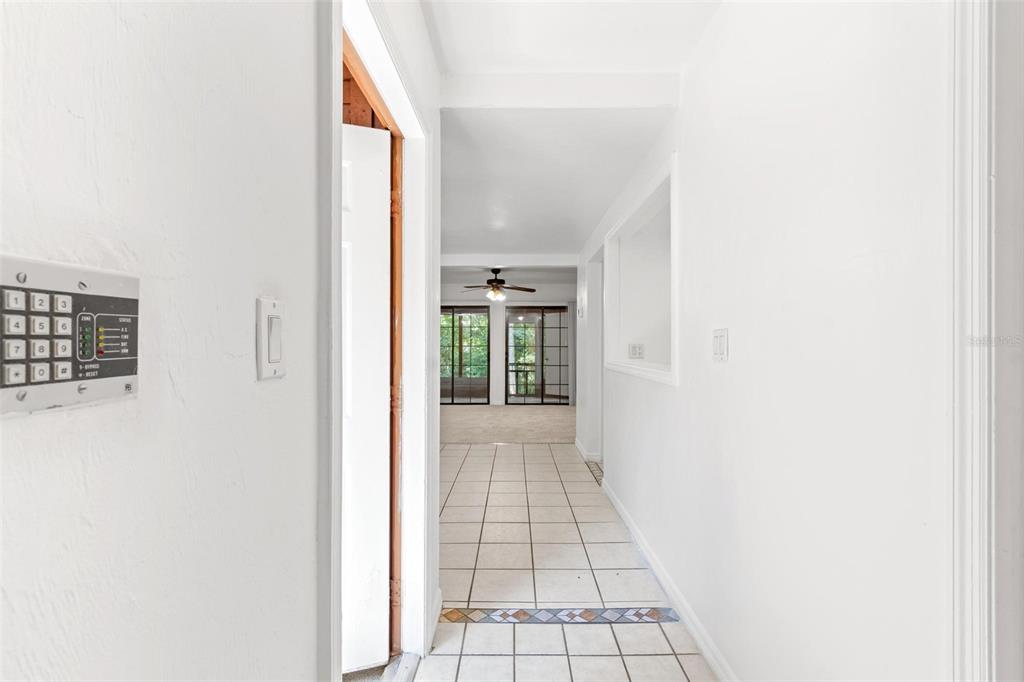 5606 Southwest 8th Place Gainesville, FL 32607 - Photo 15 of 24 a view of a hallway with wooden floor and a white wall