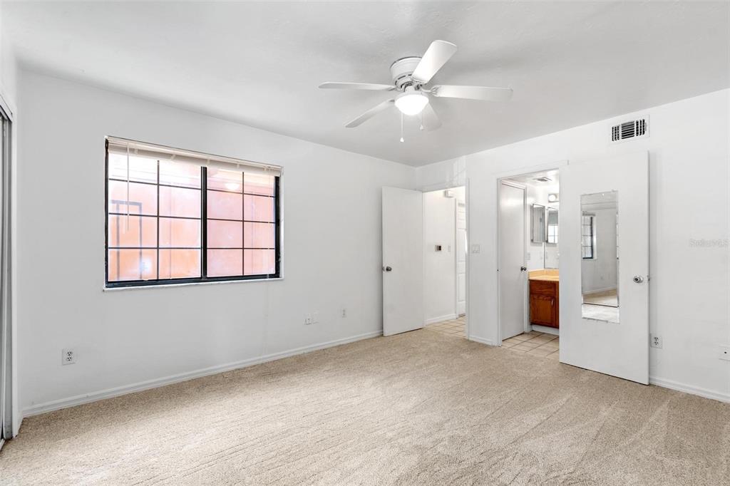 5606 Southwest 8th Place Gainesville, FL 32607 - Photo 19 of 24 an empty room with fan and windows