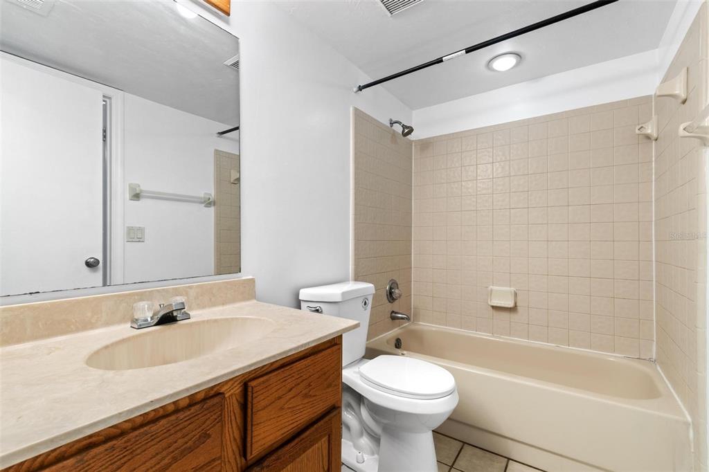 5606 Southwest 8th Place Gainesville, FL 32607 - Photo 20 of 24 a bathroom with a sink toilet vanity and shower