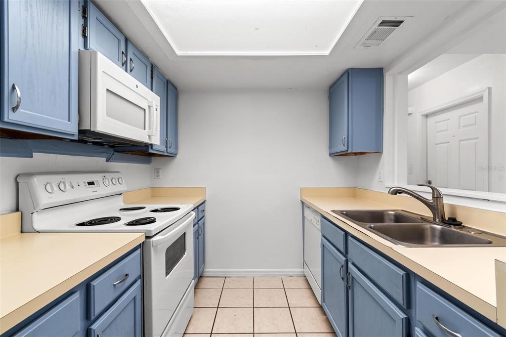 5606 Southwest 8th Place Gainesville, FL 32607 - Photo 6 of 24 a kitchen with stainless steel appliances granite countertop a sink and cabinets