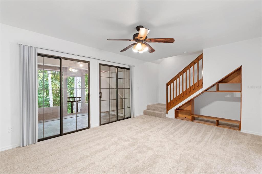 5606 Southwest 8th Place Gainesville, FL 32607 - Photo 9 of 24 a view of empty room with stairs and windows