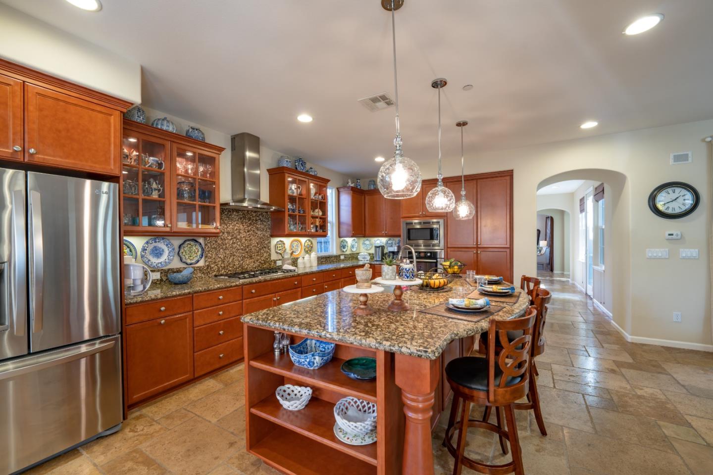 7683 Braid Court Gilroy, CA 95020 - Photo 17 of 69 a kitchen with stainless steel appliances granite countertop a kitchen island a table and chairs in it