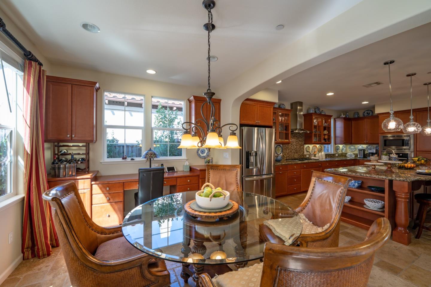 7683 Braid Court Gilroy, CA 95020 - Photo 21 of 69 a view of a dining room with furniture a kitchen and chandelier
