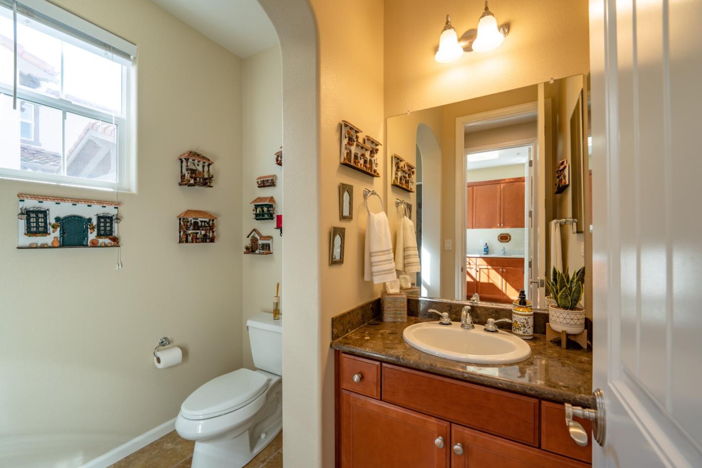 7683 Braid Court Gilroy, CA 95020 - Photo 28 of 69 a bathroom with a granite countertop sink toilet and shower