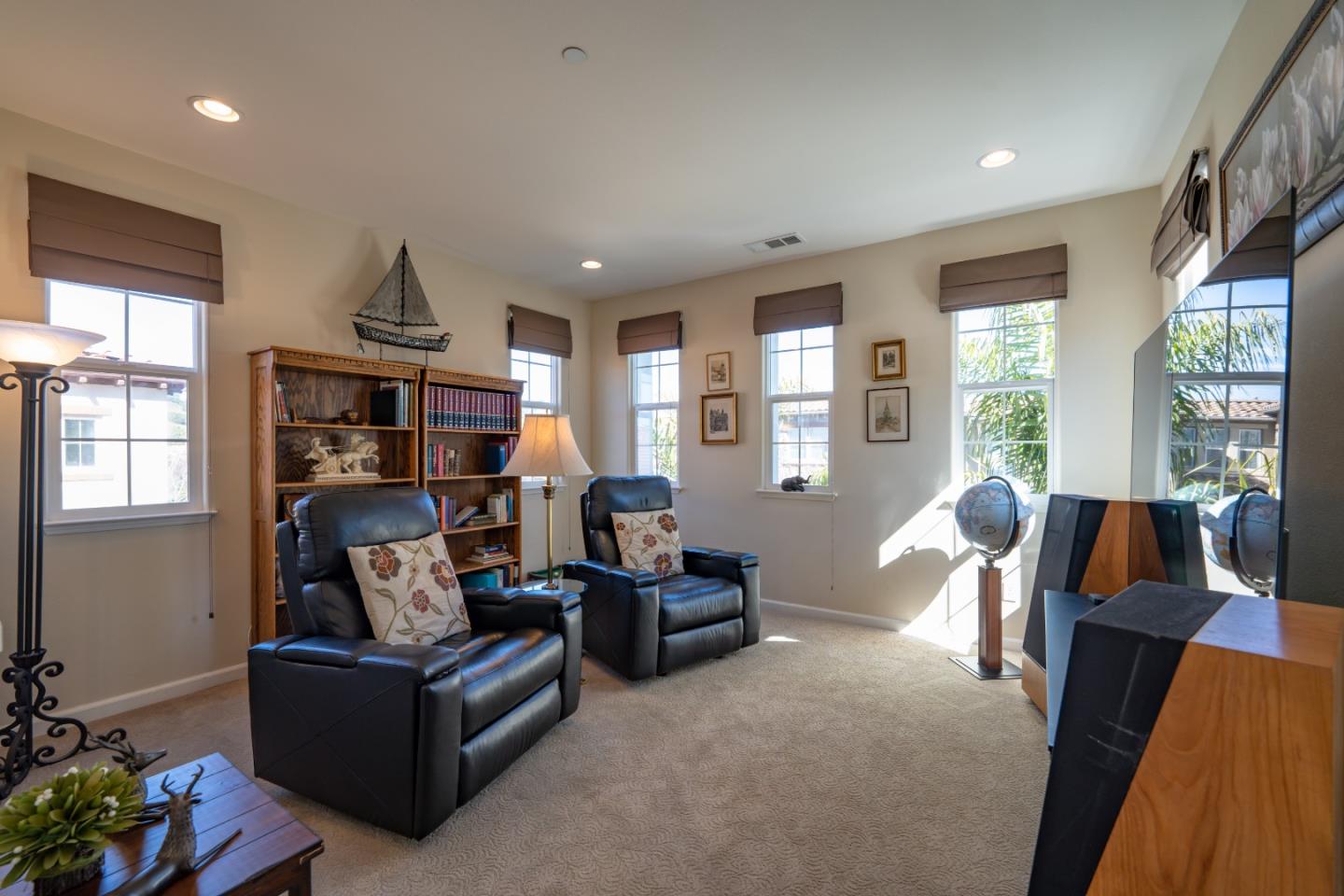 7683 Braid Court Gilroy, CA 95020 - Photo 31 of 69 a living room with furniture a bookshelf and a large window