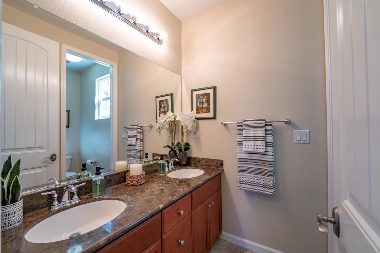 7683 Braid Court Gilroy, CA 95020 - Photo 36 of 69 a bathroom with a granite countertop double vanity sink and a mirror