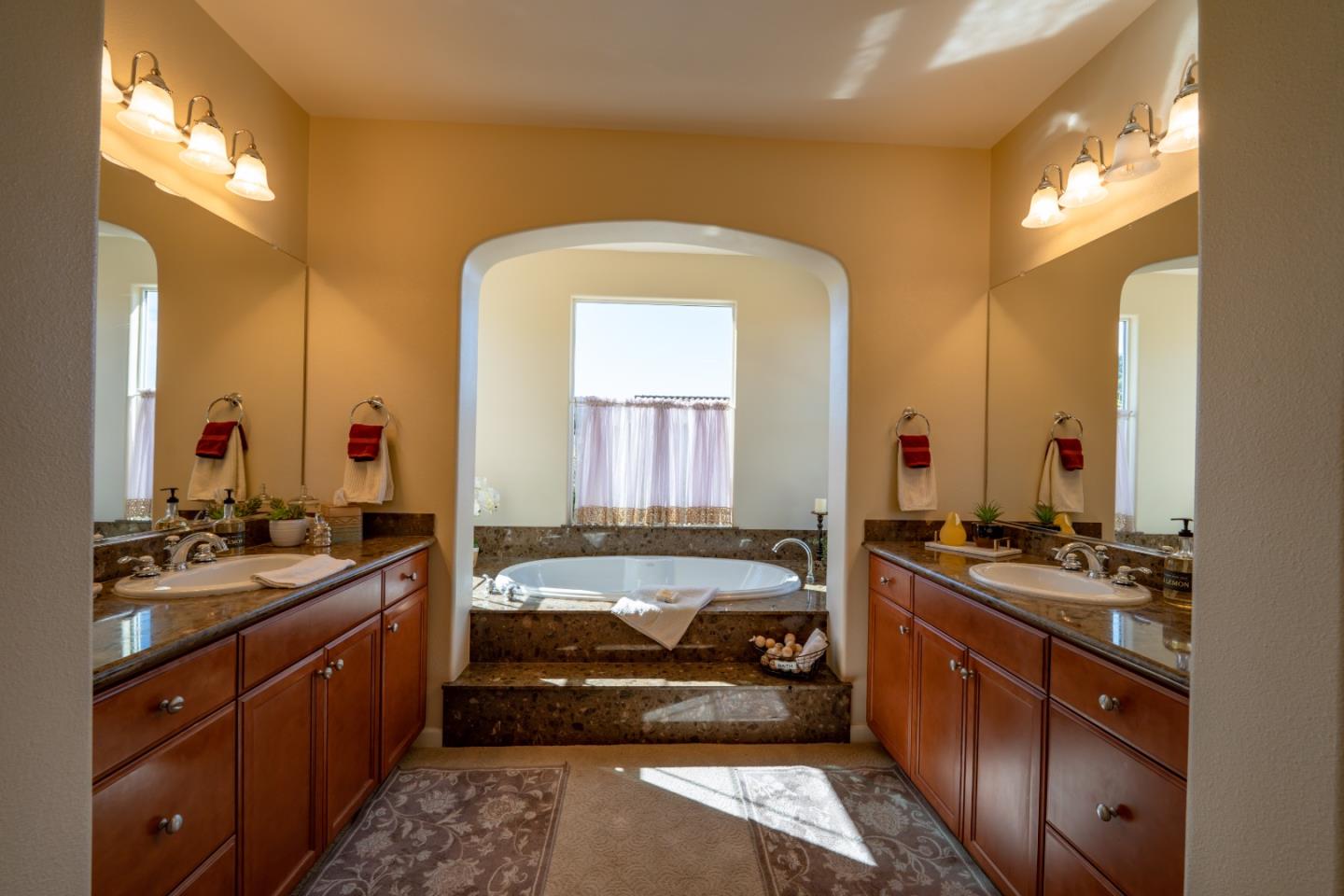 7683 Braid Court Gilroy, CA 95020 - Photo 48 of 69 a en suite bathroom with a sink and a mirror