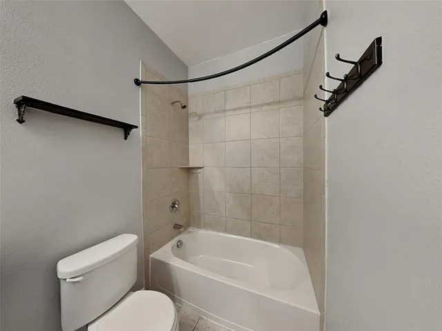 a bathroom with a sink toilet a mirror and shower