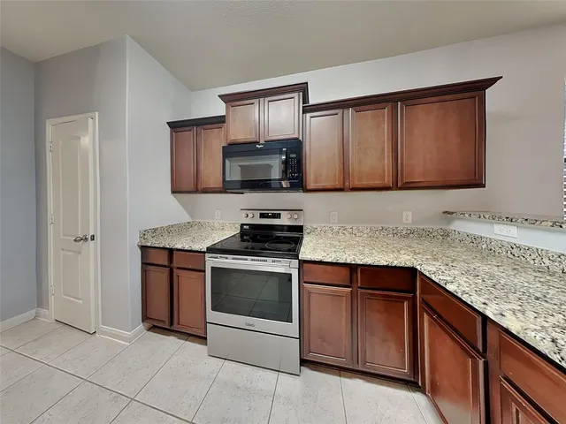 a kitchen with granite countertop cabinets and steel stainless steel appliances