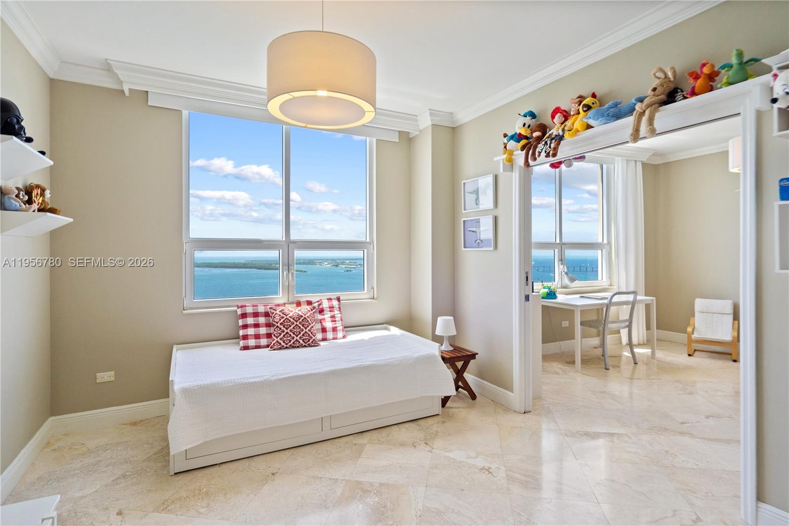 808 Brickell Key Drive, Unit 3304 Miami, FL 33131 - Photo 18 of 60 a spacious bedroom with a bed and a chandelier
