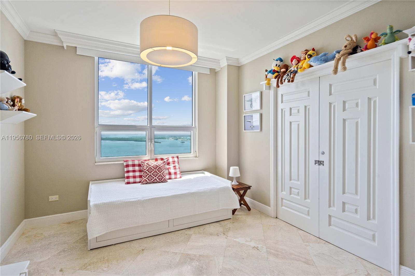 808 Brickell Key Drive, Unit 3304 Miami, FL 33131 - Photo 19 of 60 a spacious bedroom with a bed and a window