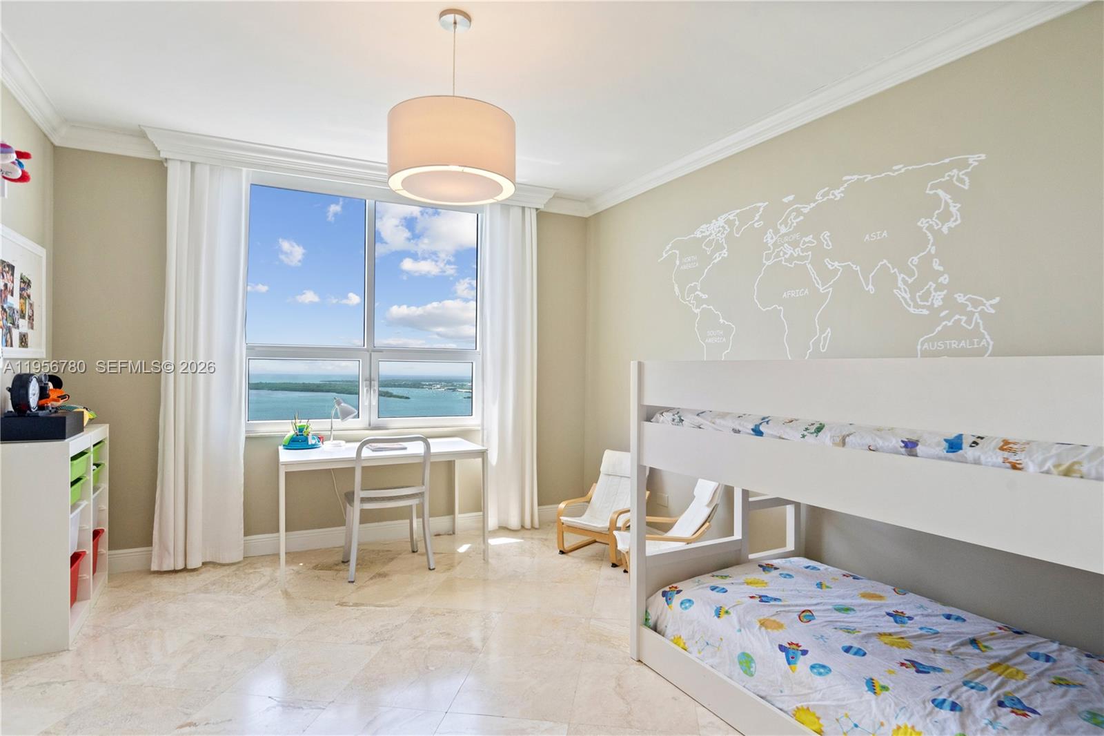 808 Brickell Key Drive, Unit 3304 Miami, FL 33131 - Photo 20 of 60 a bedroom with furniture and a chandelier