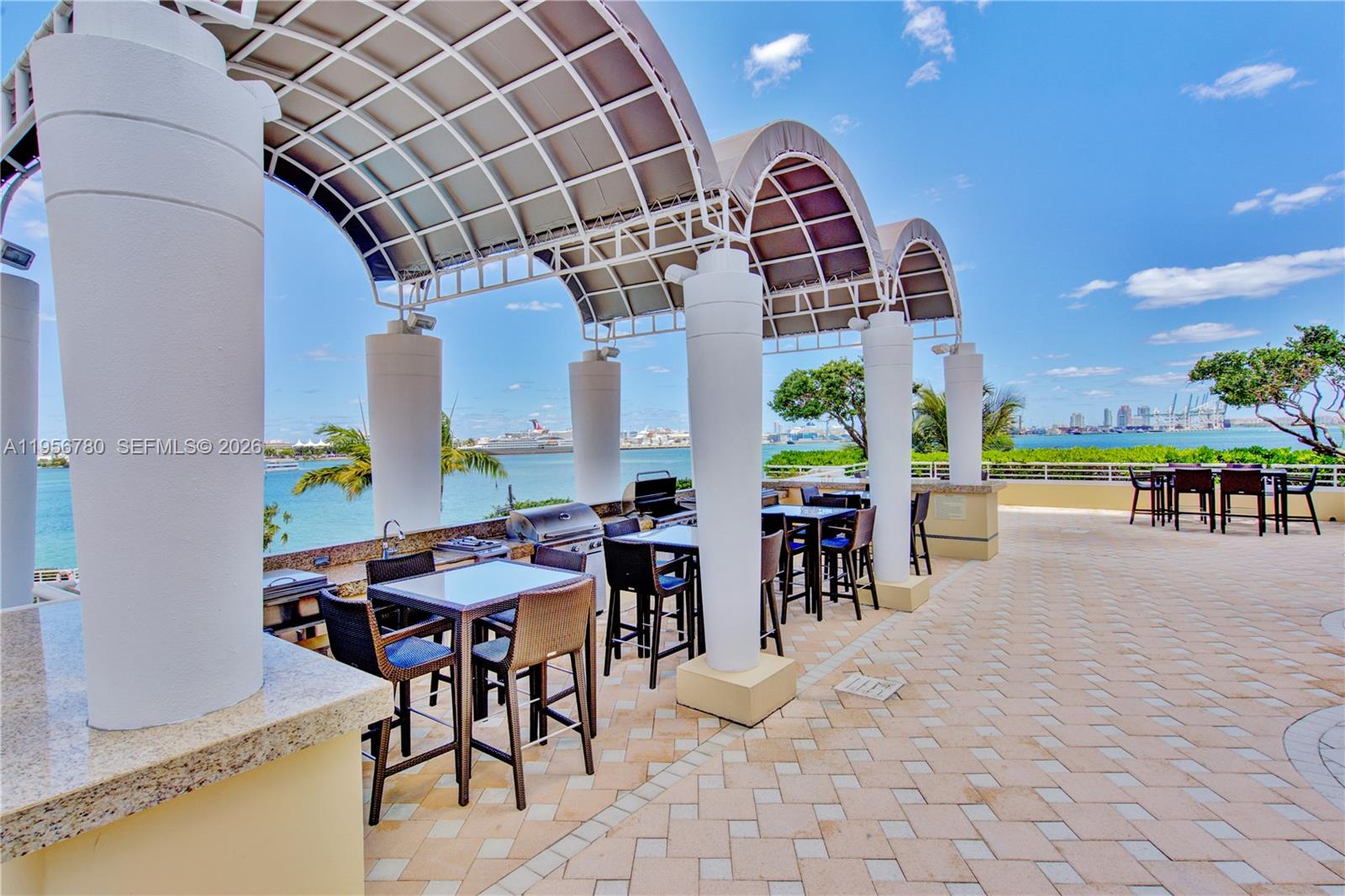 808 Brickell Key Drive, Unit 3304 Miami, FL 33131 - Photo 53 of 60 a view of a dining room with furniture one side kitchen view and wooden floor