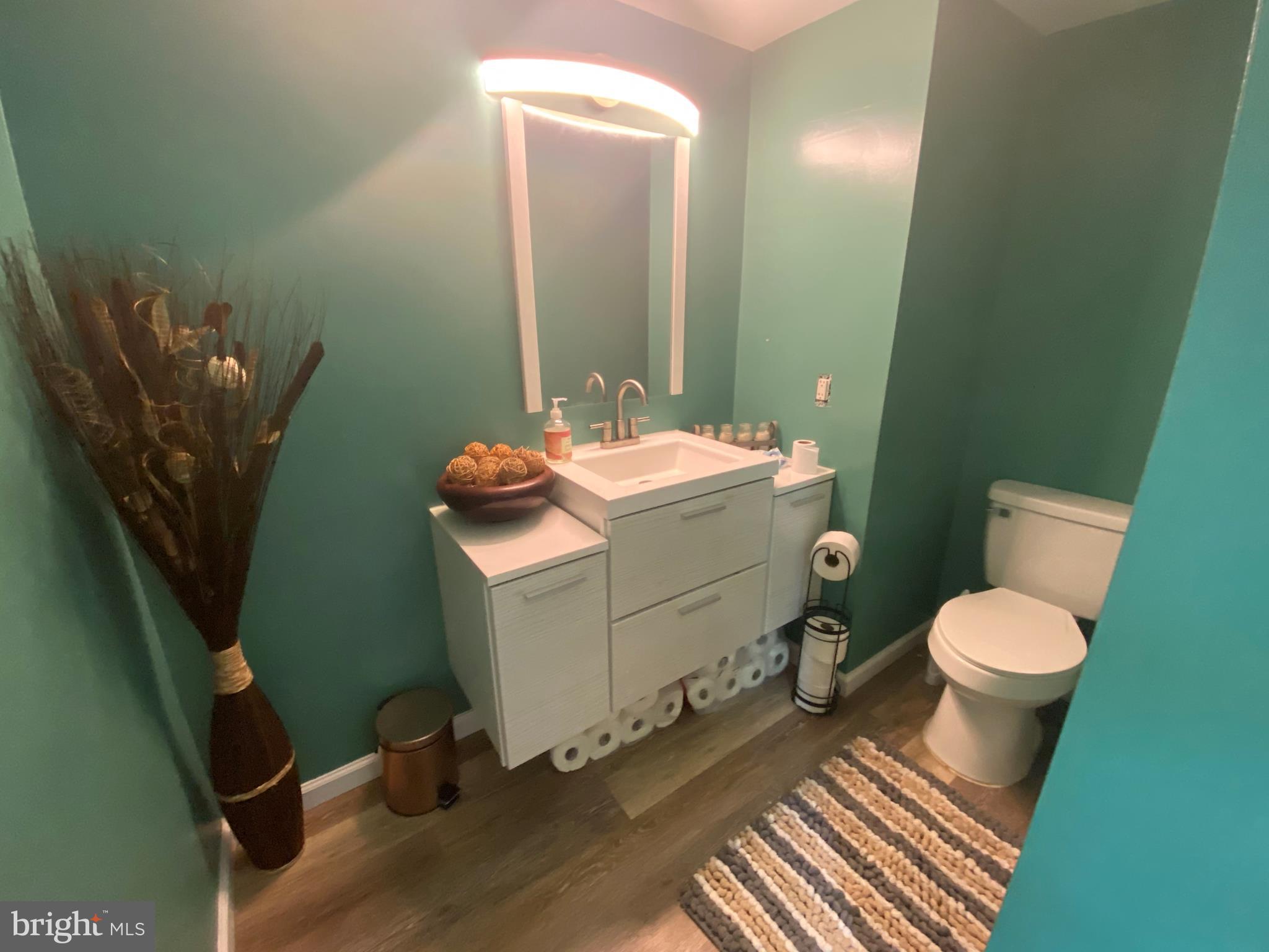 14526 Banquo Terrace, Unit 72 Silver Spring, MD 20906 - Photo 12 of 24 a bathroom with a sink toilet and mirror