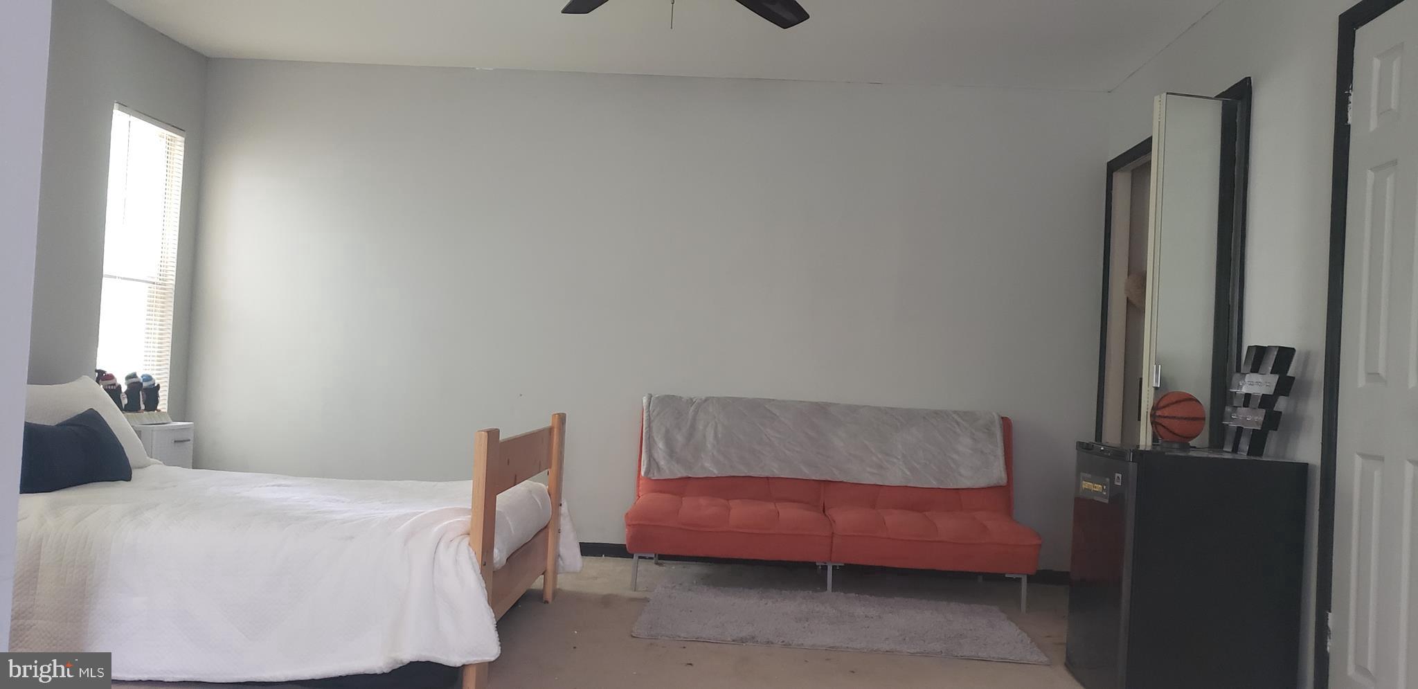 14526 Banquo Terrace, Unit 72 Silver Spring, MD 20906 - Photo 15 of 24 a bedroom with a bed and a couch