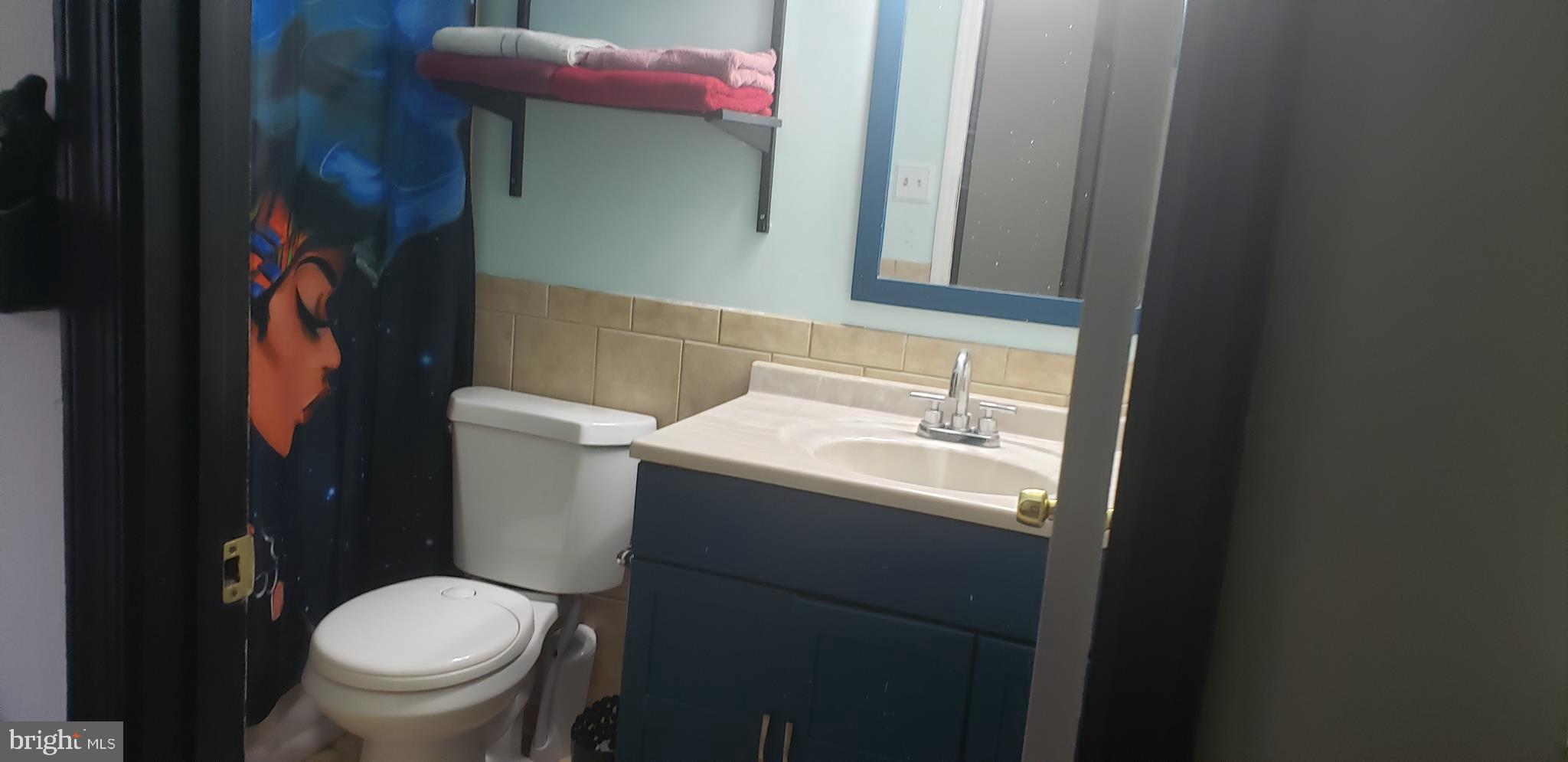 14526 Banquo Terrace, Unit 72 Silver Spring, MD 20906 - Photo 16 of 24 a bathroom with a toilet sink and mirror