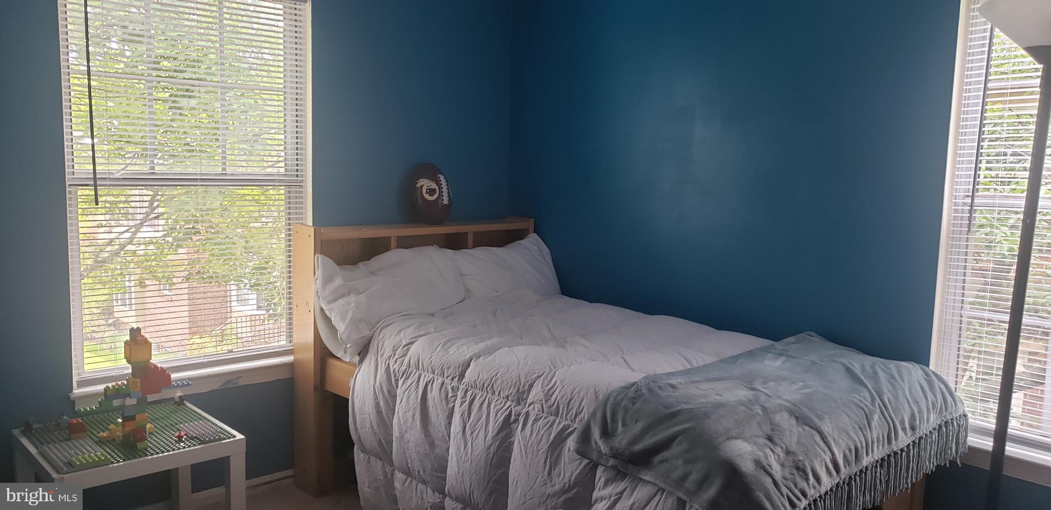 14526 Banquo Terrace, Unit 72 Silver Spring, MD 20906 - Photo 17 of 24 a bed sitting in a bedroom next to a window