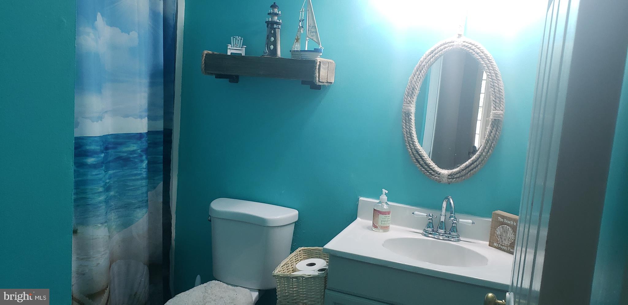 14526 Banquo Terrace, Unit 72 Silver Spring, MD 20906 - Photo 20 of 24 a bathroom with a toilet sink and mirror