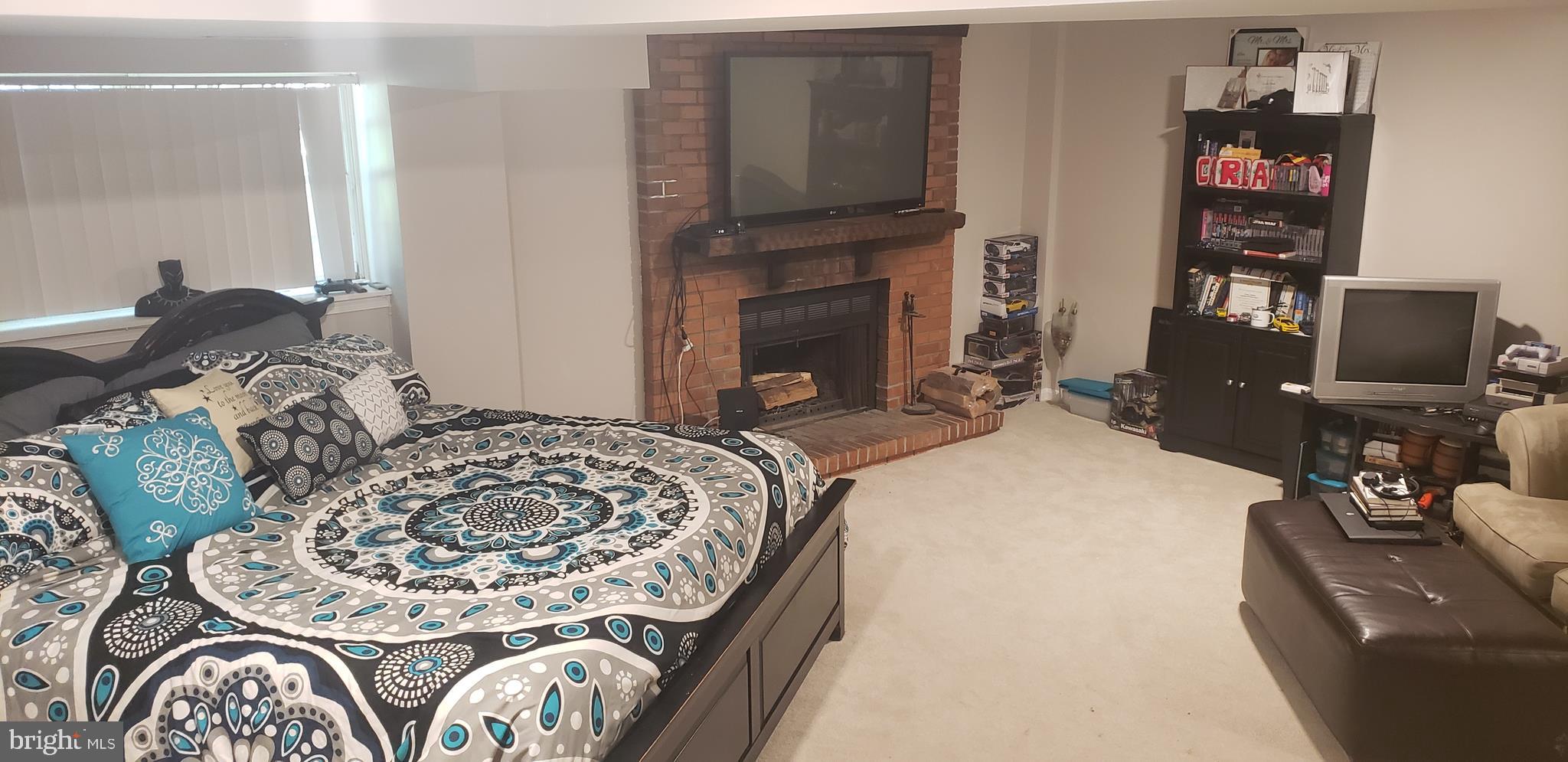 14526 Banquo Terrace, Unit 72 Silver Spring, MD 20906 - Photo 21 of 24 a bed sitting in a bedroom next to a fireplace