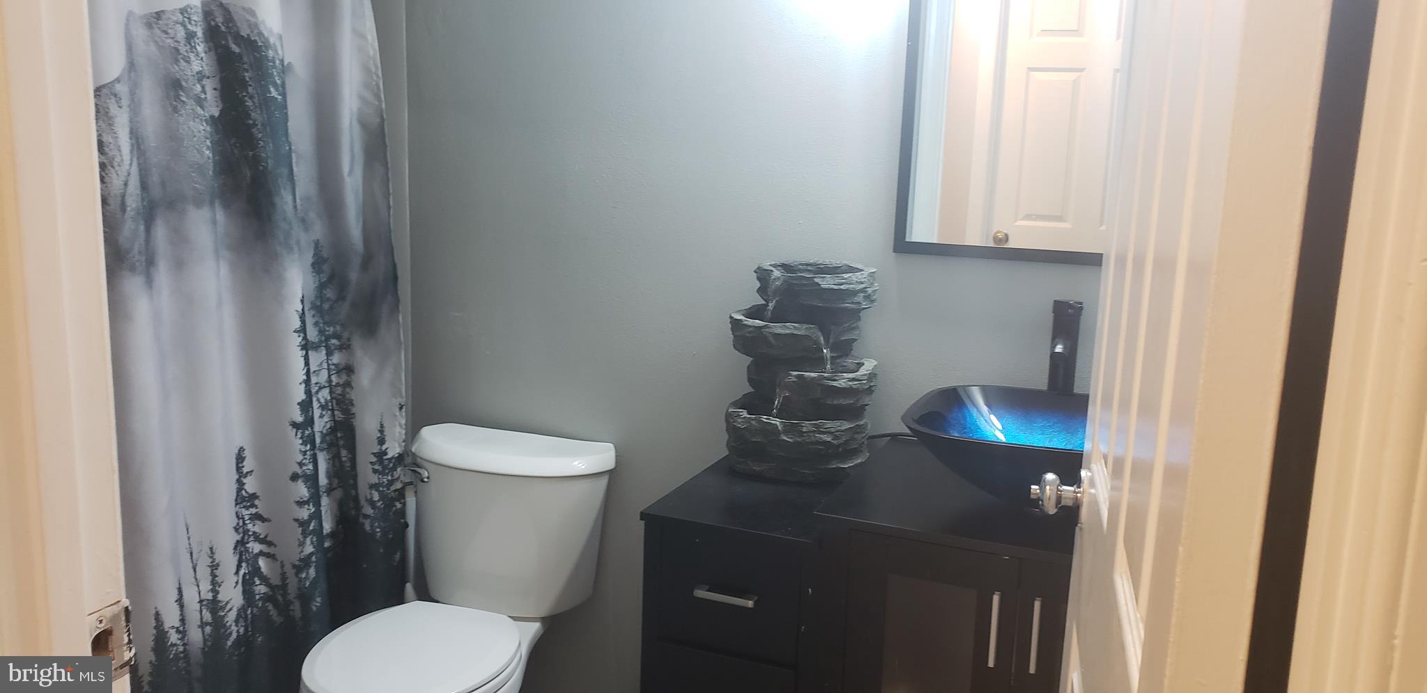 14526 Banquo Terrace, Unit 72 Silver Spring, MD 20906 - Photo 22 of 24 a white toilet sitting next to a bathroom sink