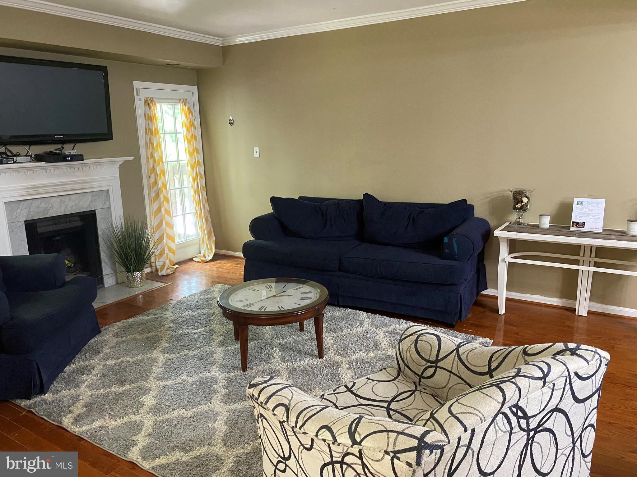 14526 Banquo Terrace, Unit 72 Silver Spring, MD 20906 - Photo 4 of 24 a living room with furniture a flat screen tv and a fireplace