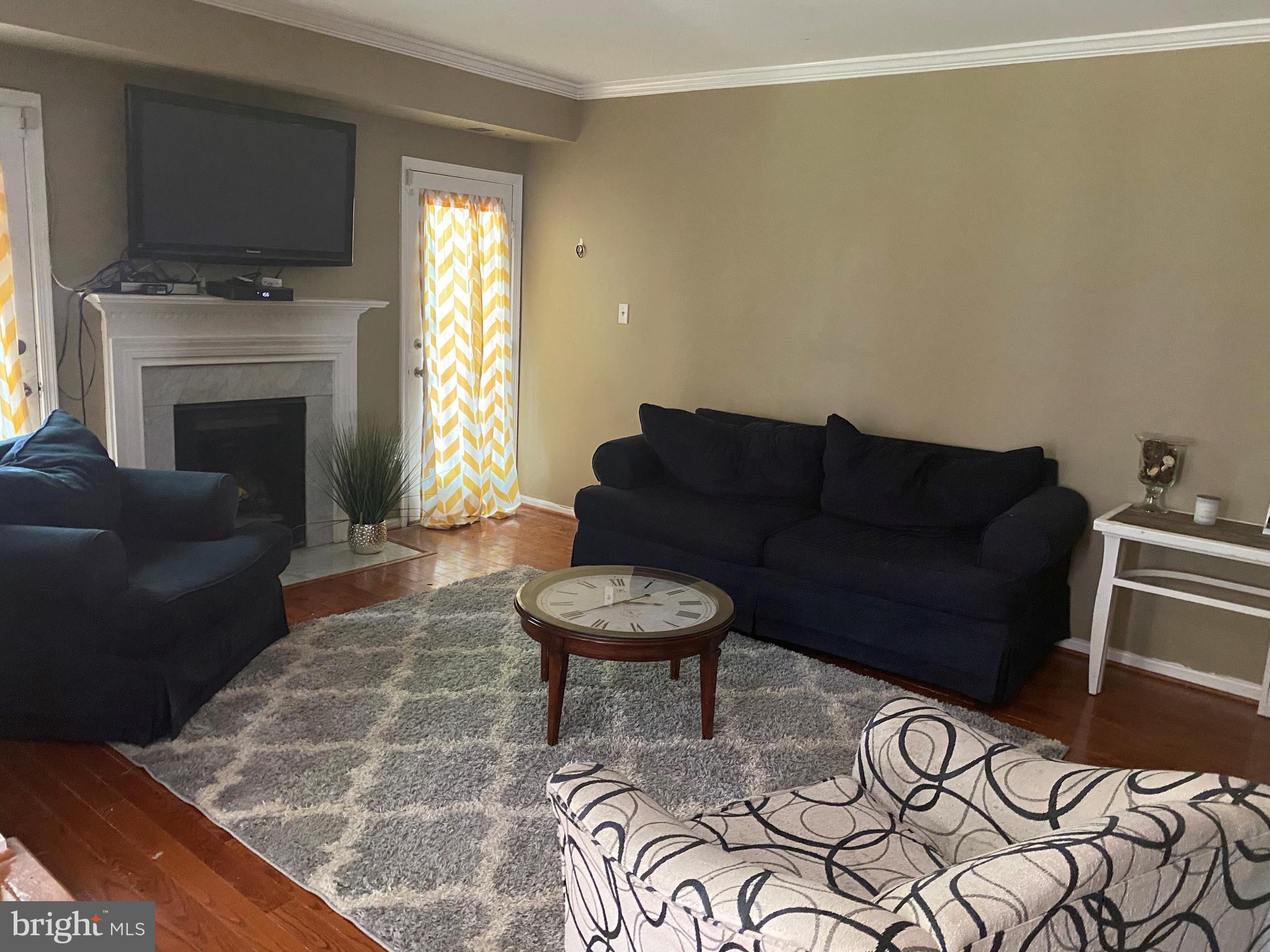 14526 Banquo Terrace, Unit 72 Silver Spring, MD 20906 - Photo 5 of 24 a living room with furniture a flat screen tv and a fireplace