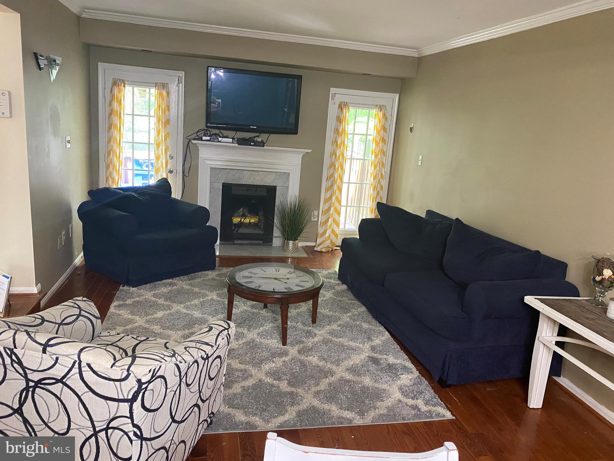 14526 Banquo Terrace, Unit 72 Silver Spring, MD 20906 - Photo 6 of 24 a living room with furniture a flat screen tv and a fireplace