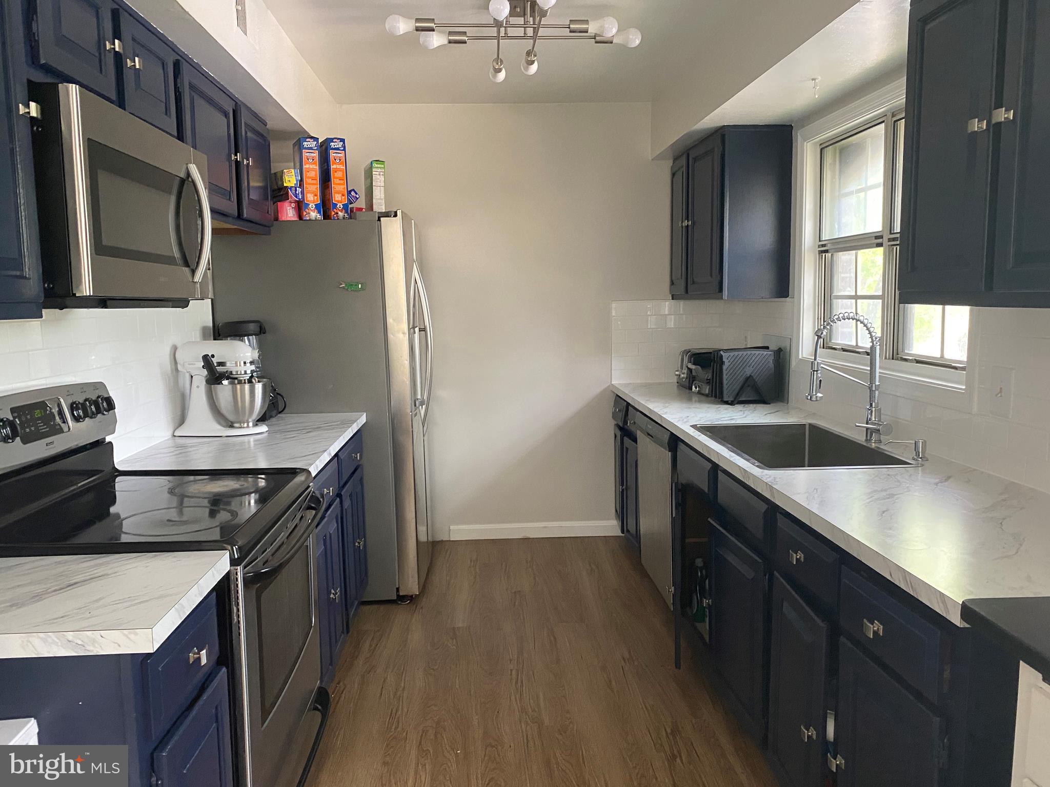14526 Banquo Terrace, Unit 72 Silver Spring, MD 20906 - Photo 8 of 24 a kitchen with stainless steel appliances granite countertop a sink stove and refrigerator