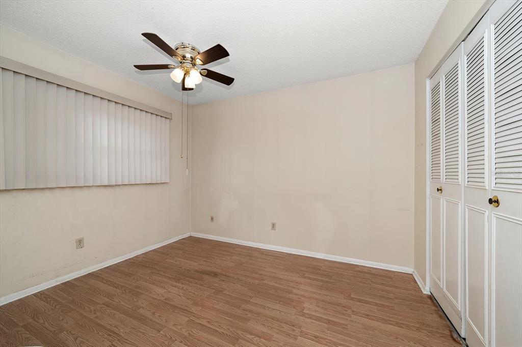 2850 Spring Lake Drive Clearwater, FL 33759 - Photo 18 of 37 wooden floor in an empty room with a window