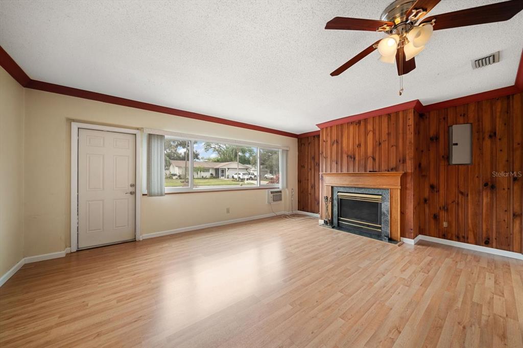 2850 Spring Lake Drive Clearwater, FL 33759 - Photo 2 of 37 a view of an empty room with a fireplace and a window