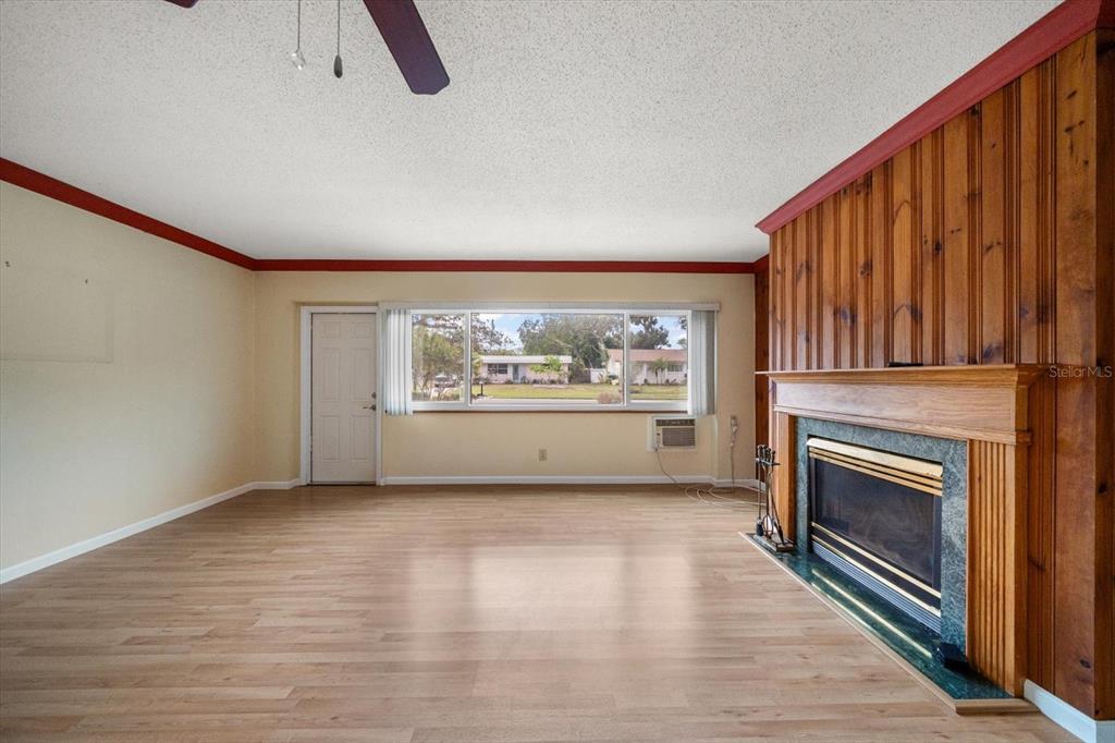 2850 Spring Lake Drive Clearwater, FL 33759 - Photo 4 of 37 a view of an empty room with a fireplace and a window