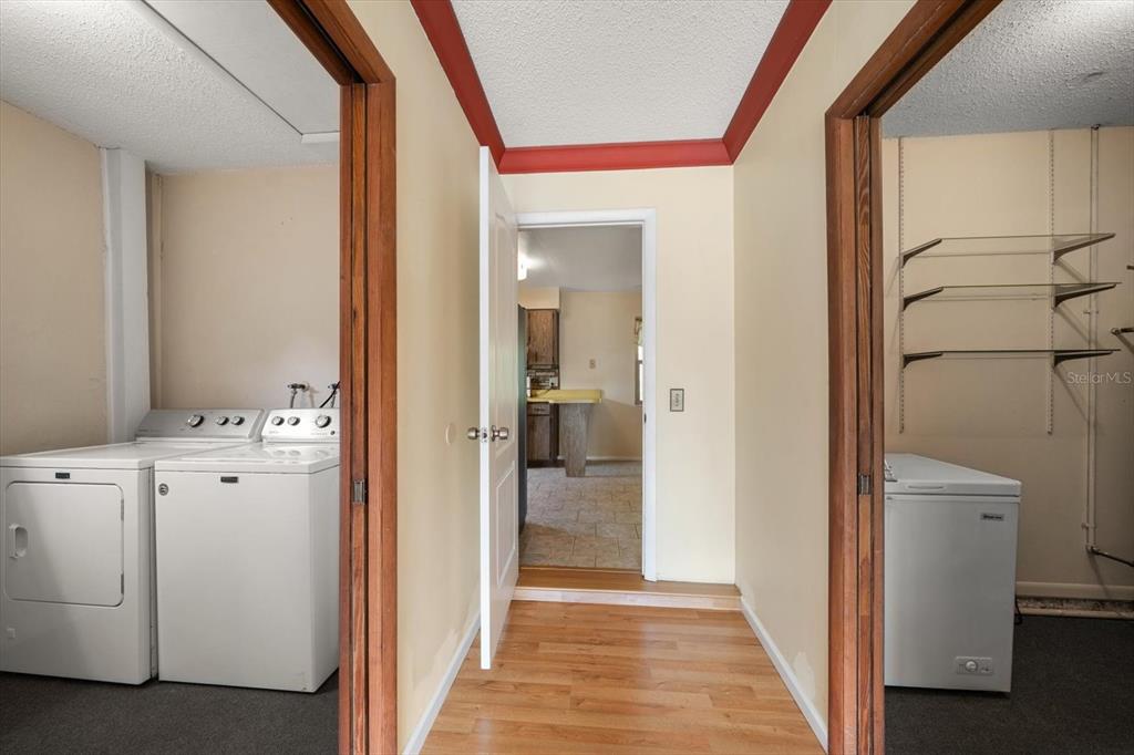 2850 Spring Lake Drive Clearwater, FL 33759 - Photo 6 of 37 a view of a hallway with closet and wooden floor