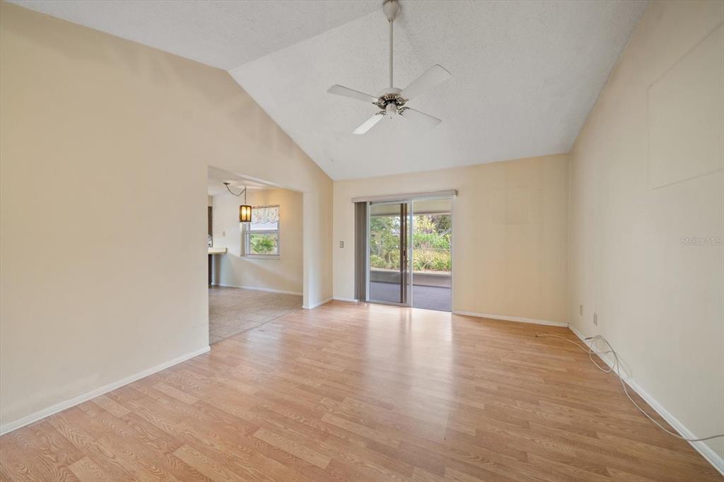 2850 Spring Lake Drive Clearwater, FL 33759 - Photo 8 of 37 a view of an empty room with a window and wooden floor