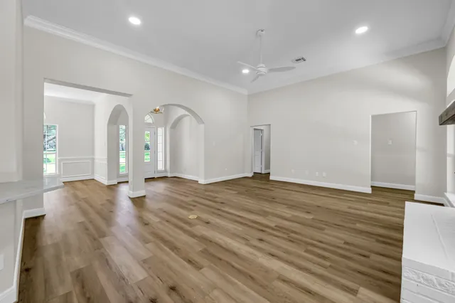 a view of empty room with wooden floor