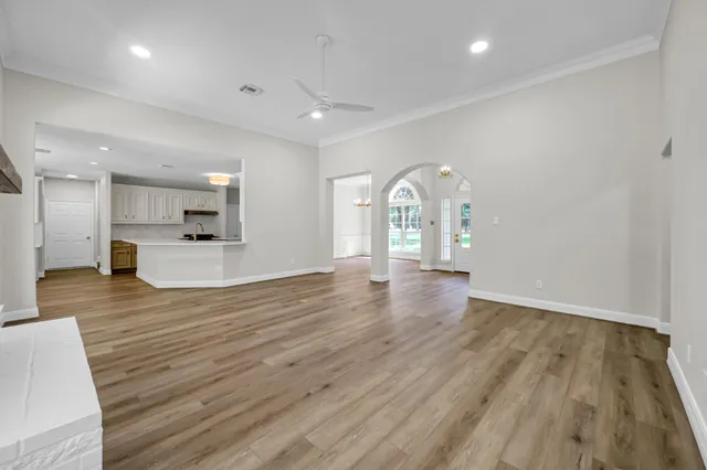 a view of kitchen and hall with wooden floor