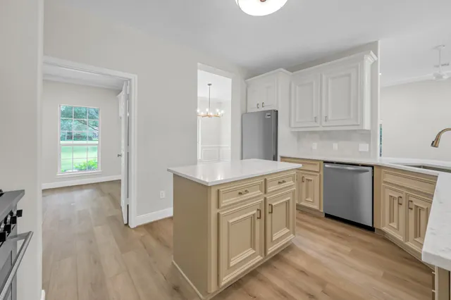a kitchen with white cabinets and white appliances