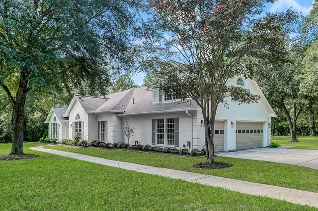 a front view of house with yard and green space