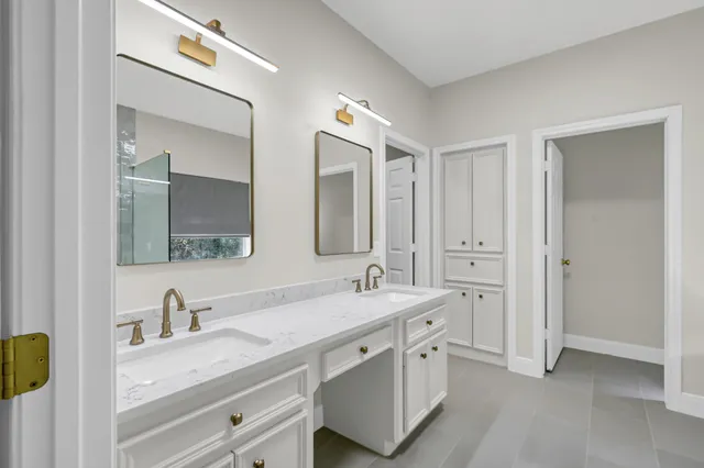 a bathroom with double sink and a mirror