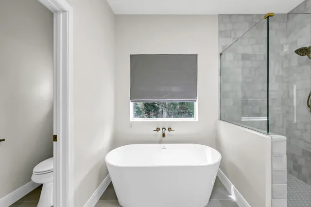 a white bath tub sitting next to a white sink