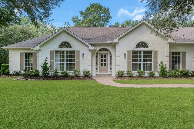 a front view of a house with a yard and porch