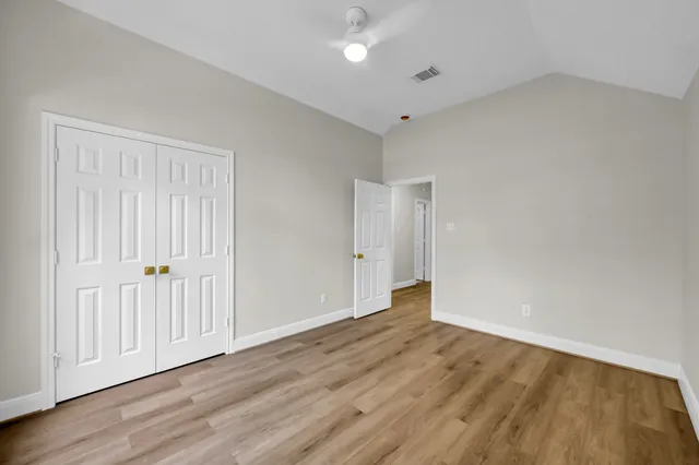a view of an empty room with wooden floor