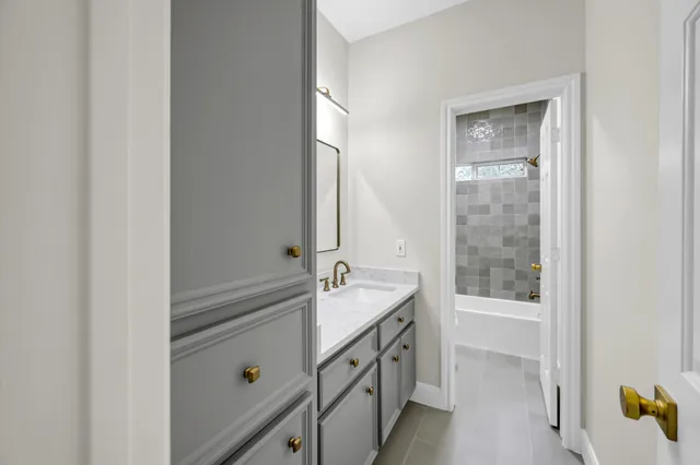 a bathroom with a tub sink and mirror