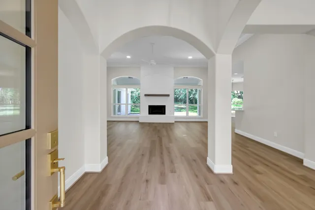 wooden floor in an empty room with a window