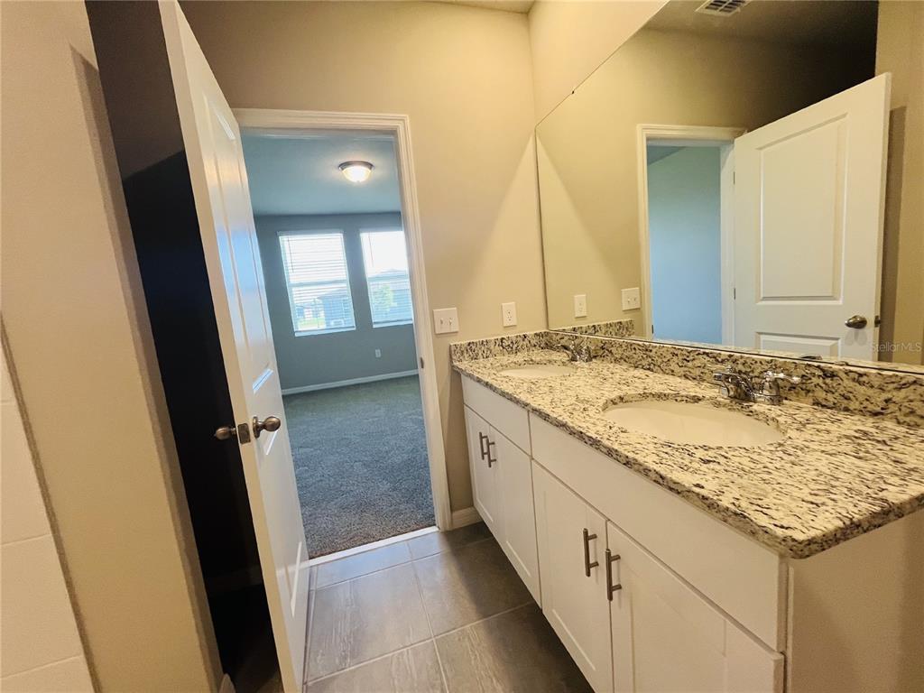 1061 Oak Vly Drive Auburndale, FL 33823 - Photo 12 of 16 a bathroom with a granite countertop sink and a mirror