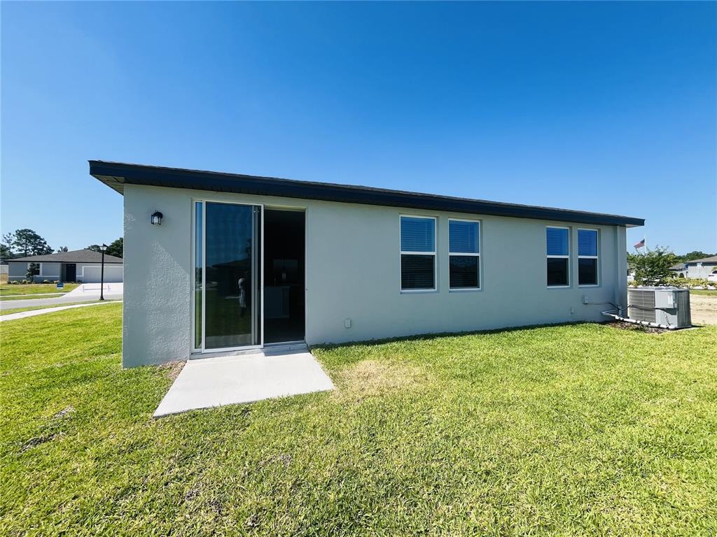 1061 Oak Vly Drive Auburndale, FL 33823 - Photo 15 of 16 a backyard of a house with table and chairs