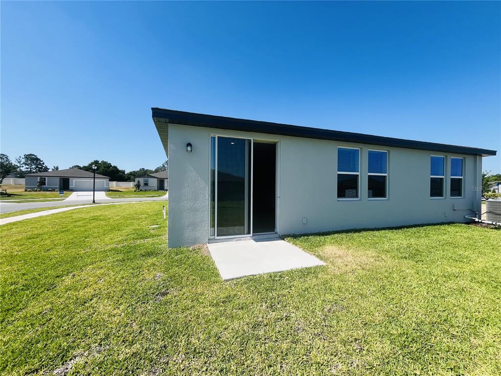 1061 Oak Vly Drive Auburndale, FL 33823 - Photo 16 of 16 a backyard of a house with yard and outdoor seating